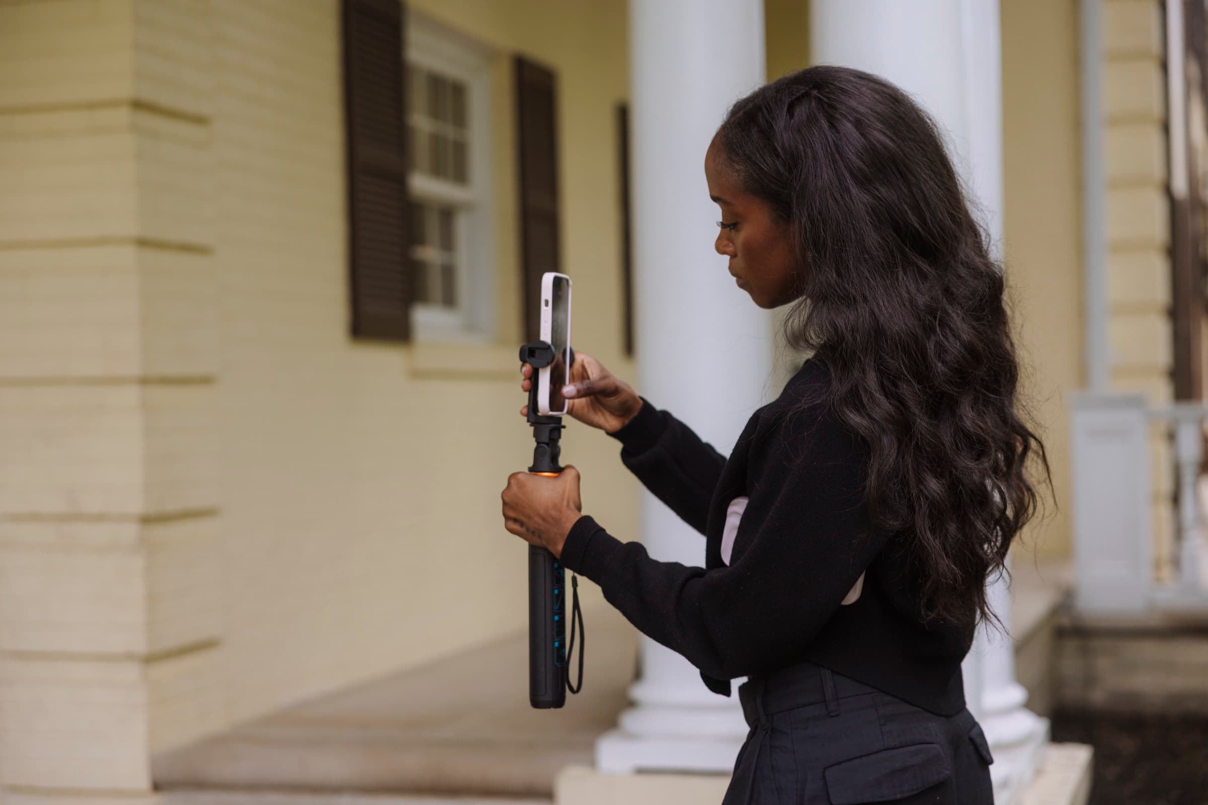 Judea adjusting her phone on a gimbal in profile