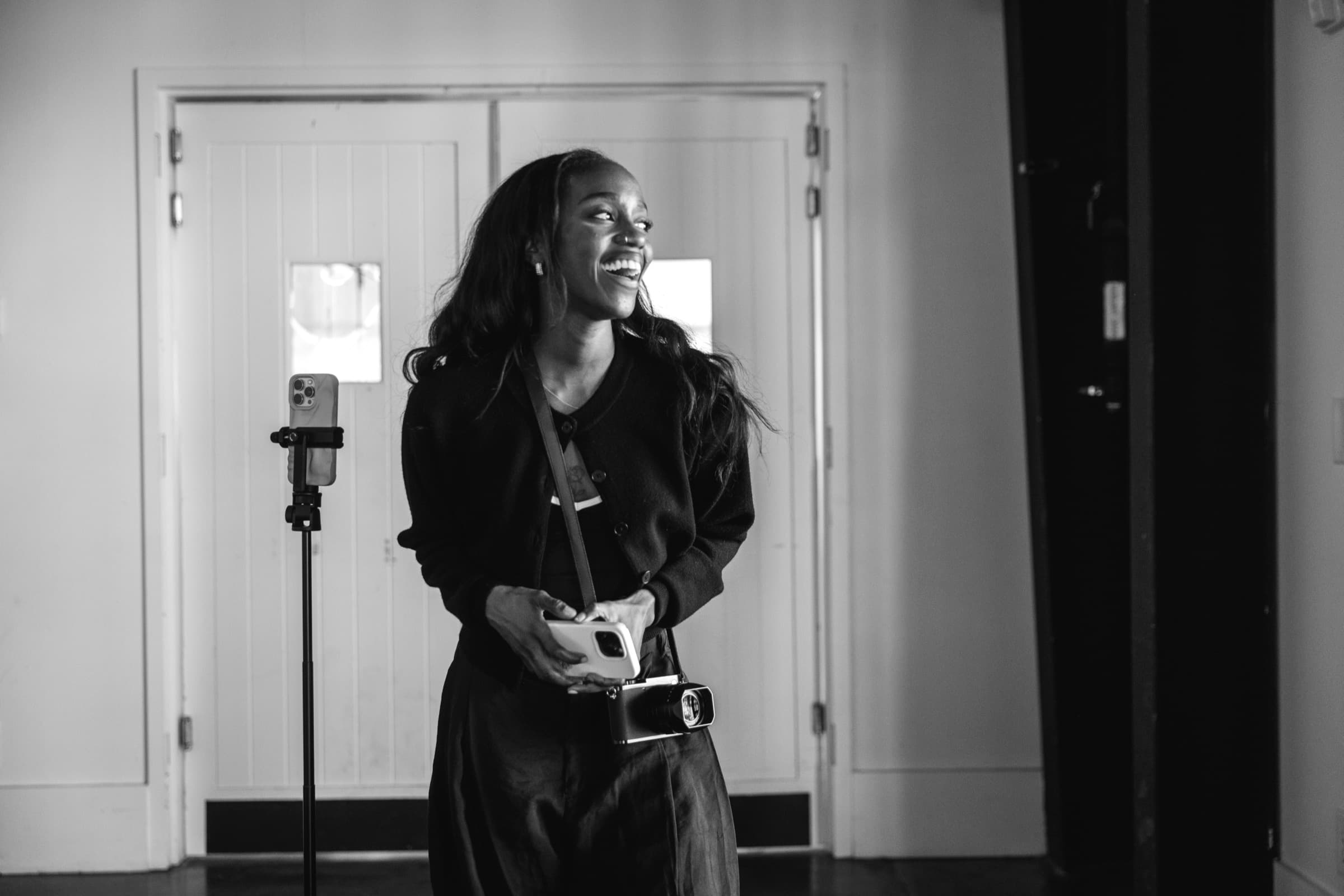 Black and white portrait of Judea laughing with dramatic contrast