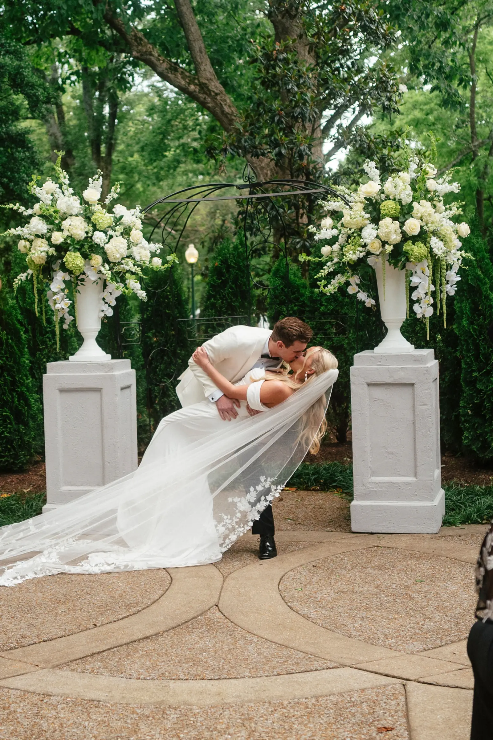 Bride and groom kiss at ceremony altar