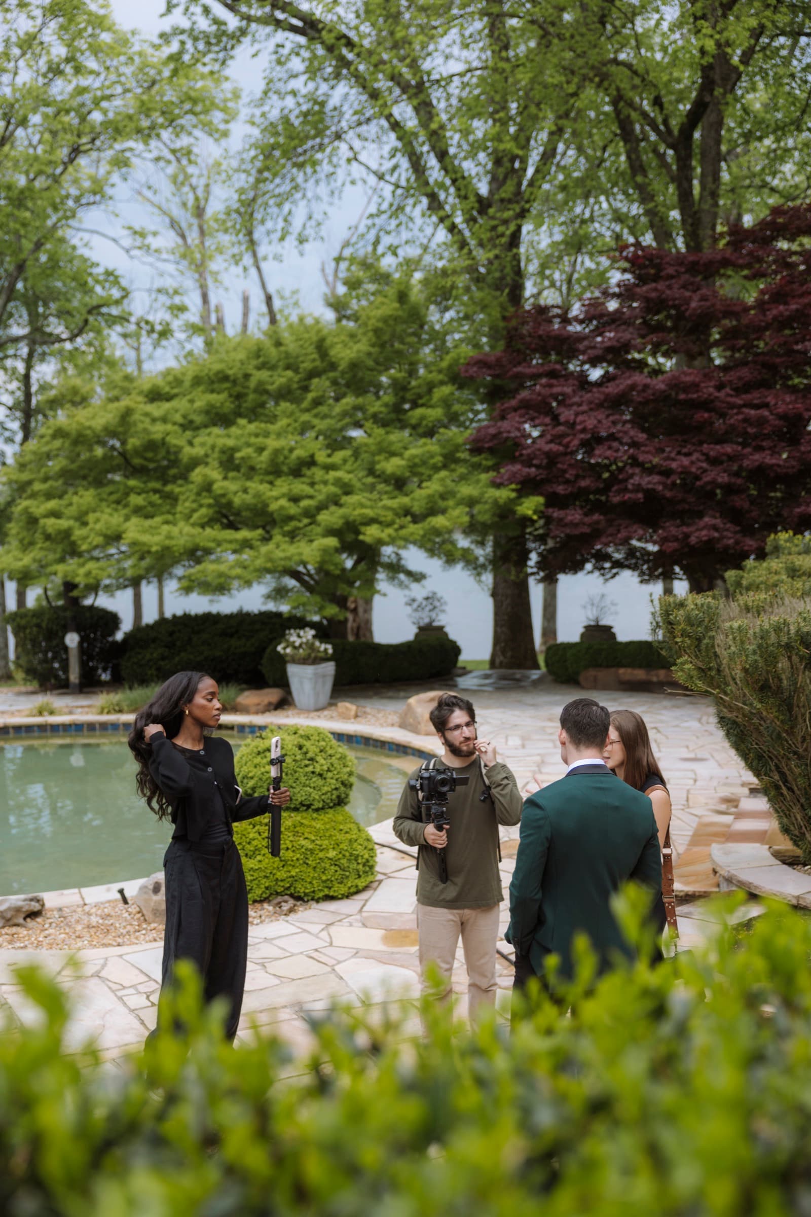 Judea capturing a couple with the vendor team at a garden wedding