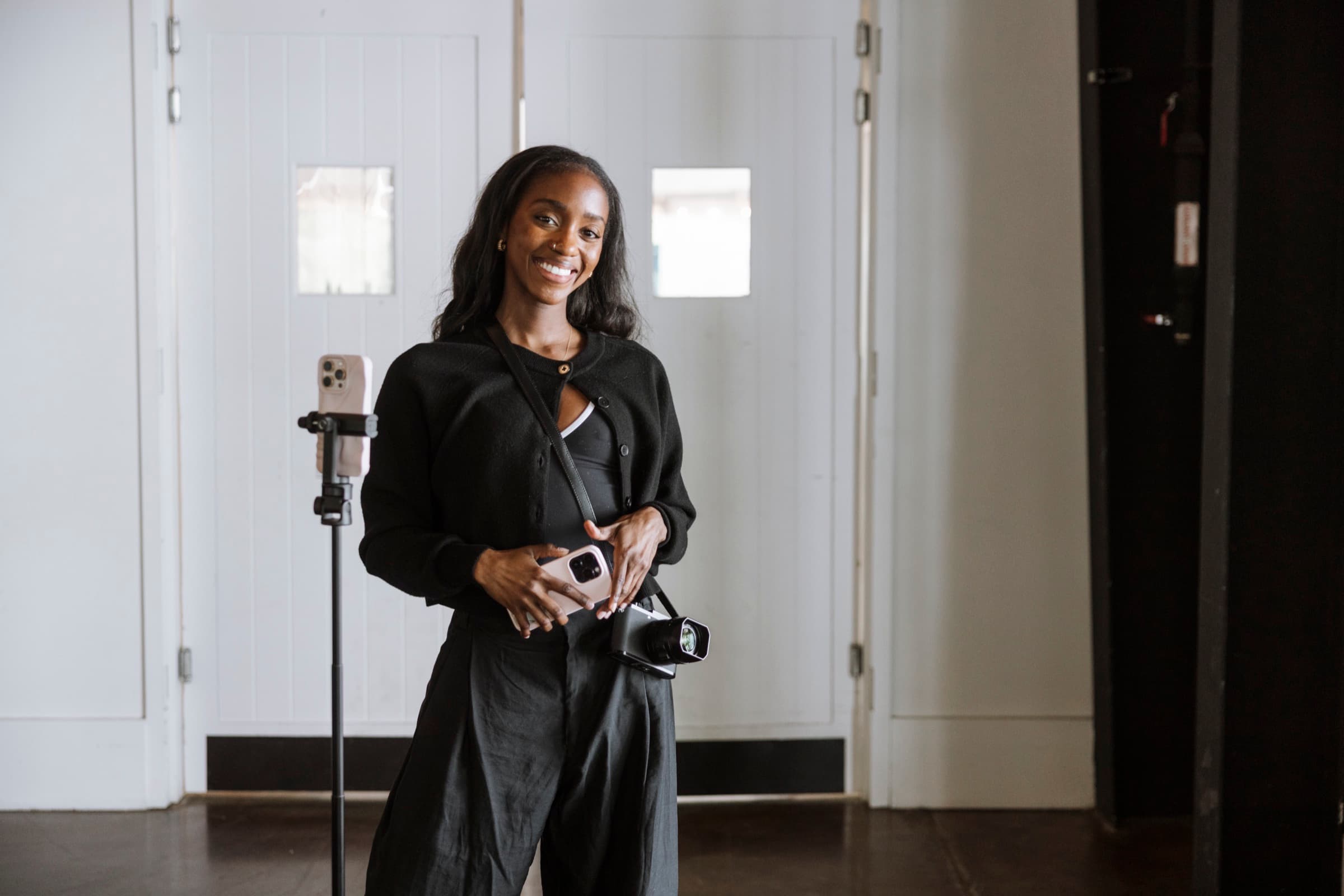 Judea smiling at the camera indoors between shots