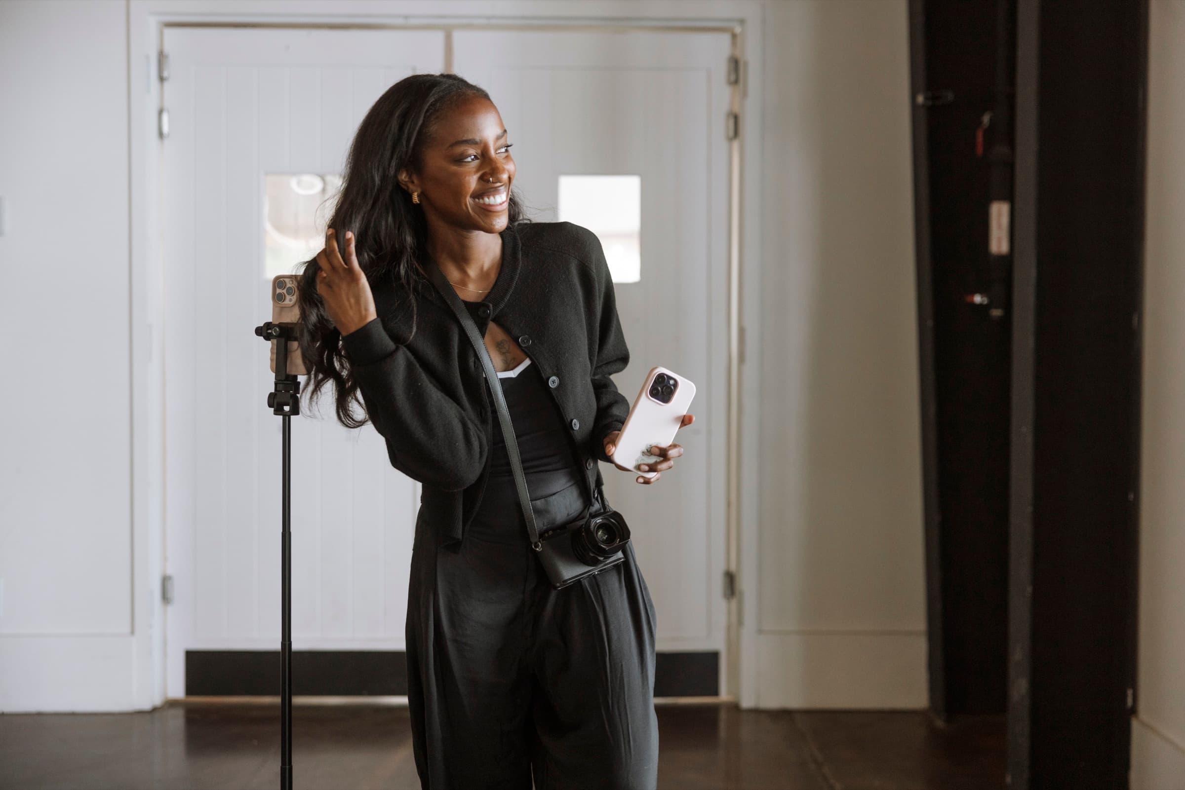 Judea touching her hair and smiling on location